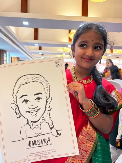 The pure delight on a child's face is priceless. Here's a young guest proudly showing off her black and white ink caricature, a fun party favor she can cherish.