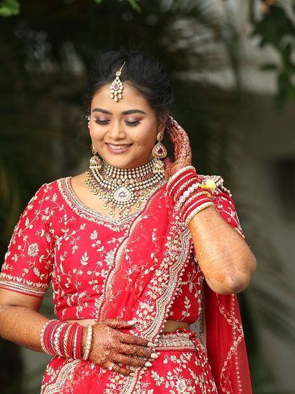 A happy, candid shot of Akanksha at her reception. Her glowing makeup ensures she looks flawless and feels confident throughout the celebration.