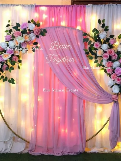 A pretty-in-pink Roka decoration. The golden ring frame is decorated with pastel pink flowers and a flowing pink drape, creating a soft and romantic photo corner.