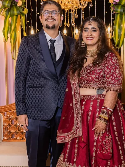 A video and photo series of this bride's reception look. She is glowing with happiness. Her makeup is glamorous with a bold red lip, and her hair is styled in soft waves, creating a stunning look for her celebration.