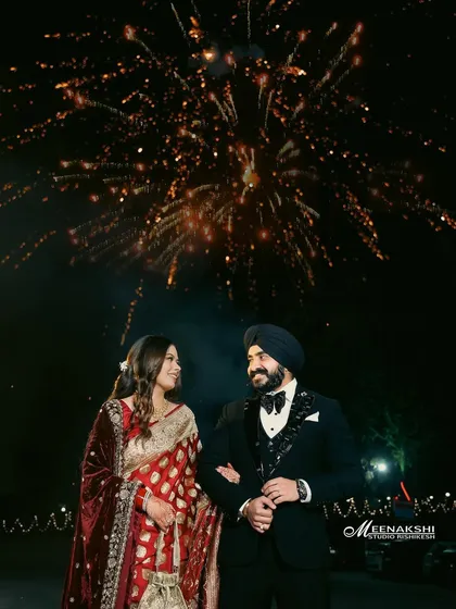 A magical reception night captured under a sky full of fireworks. I focus on framing these grand celebrations to feel both spectacular and deeply personal, highlighting the couple's joy amidst the sparkle.