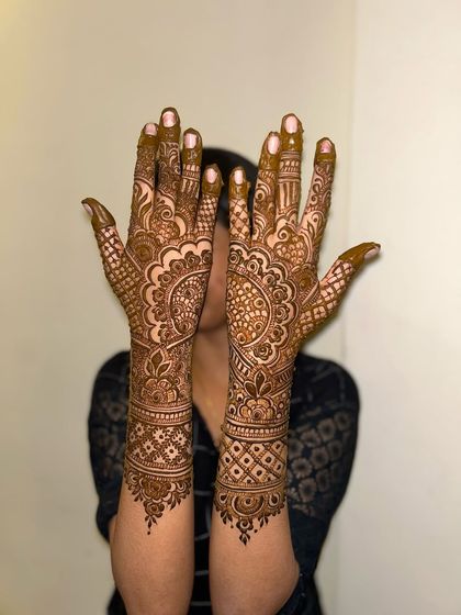 A full-coverage design that extends up the arms, featuring mandalas and intricate patterns for a classic bridal look.