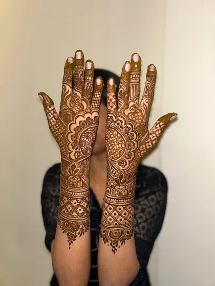 A full-coverage design that extends up the arms, featuring mandalas and intricate patterns for a classic bridal look.