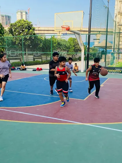 A young player drives to the basket with determination.