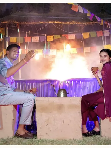 Our rustic 'dhaba' style setup, complete with a bonfire, creates a unique and cozy setting for this couple's photoshoot.
