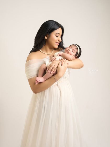 Gazing down at the tiny miracle in her arms. This quiet, loving moment between mother and newborn is the essence of what I strive to capture in my studio sessions.