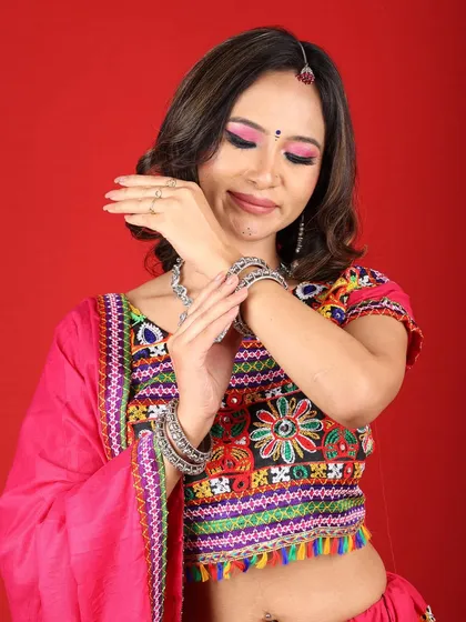 A close-up showing the details of the Navratri makeup and the beautiful silver jewelry. The pink and black smokey eye is a modern twist on a traditional look.
