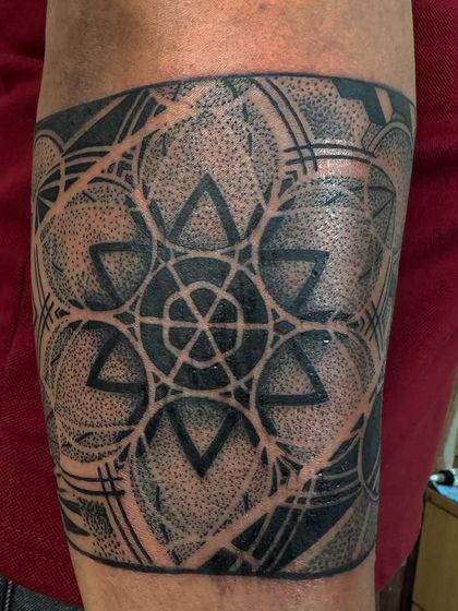 Another view of the dot work geometric armband, showing the texture and detail created by this technique.