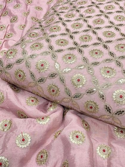Another look at the delicate baby pink Chinon fabric. Its soft texture and elegant embroidery make it a favorite for creating custom outfits for both adults and children.