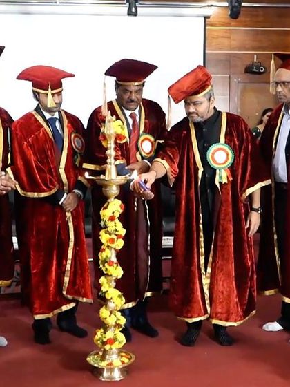 Lighting the lamp to inaugurate the graduation ceremony, a tradition symbolizing the dispelling of darkness with the light of knowledge.