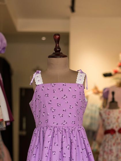 A simple and sweet lavender dress with a ditsy floral print. The lace-trimmed shoulder straps add a delicate, feminine touch to this lovely summer dress.