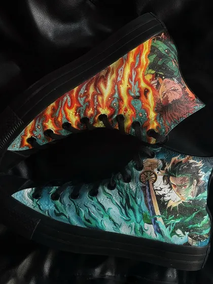 An overhead view of the custom Demon Slayer Converse, showing the detailed art wrapping around the canvas.