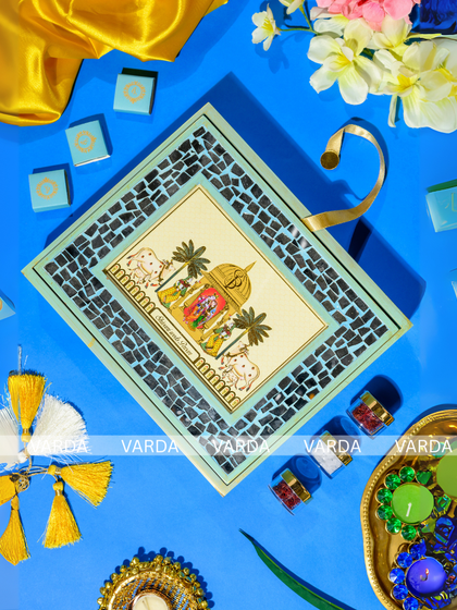 This unique Ram-Sita procession gift box is designed with reusability in mind. The lid features a beautiful illustration framed by a mosaic border, making it a perfect decorative piece or photo frame after the event.