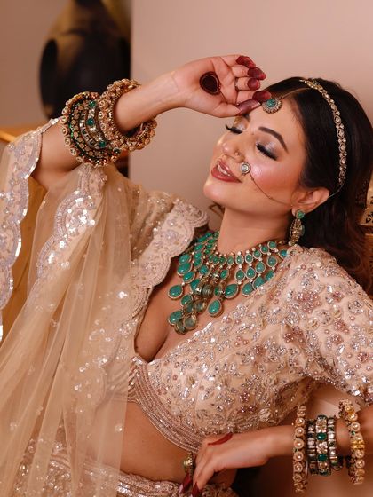 A close-up showing the details of the jewelry and the soft, blended makeup.