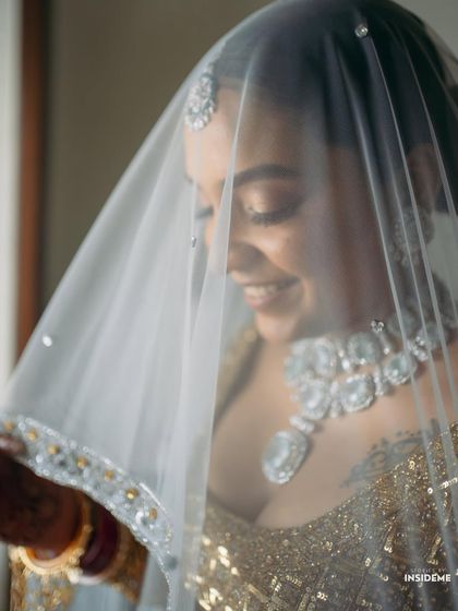 A playful and artistic shot through the veil. Mishi's happiness and the sparkle of her jewelry shine through.