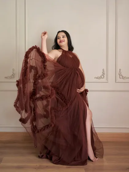 The Renee gown in a rich maroon color. The flowing tulle and high slit create a look that is both elegant and a little bit daring.