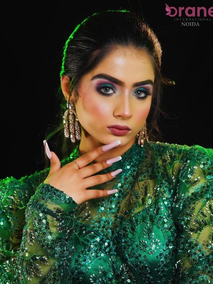 A glamorous party look with emerald green smokey eyes and long, flowing curls.