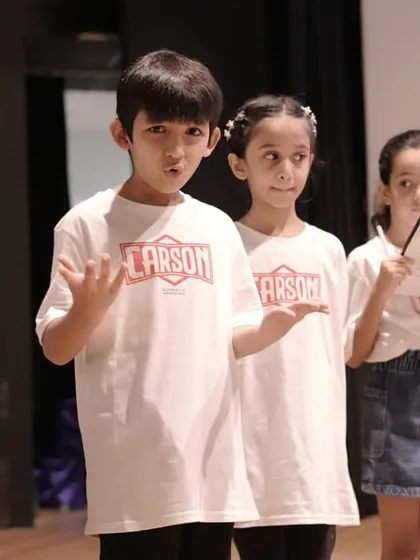 Students during a rehearsal for 'Mission Unstoppable'. Their focused expressions show the dedication that goes into preparing for a big show, learning lines, and understanding their characters.