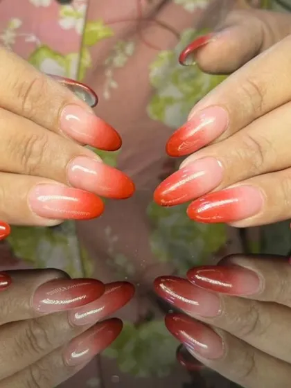 A beautiful red ombre set, fading from a soft nude base to a rich, classic red at the tips.