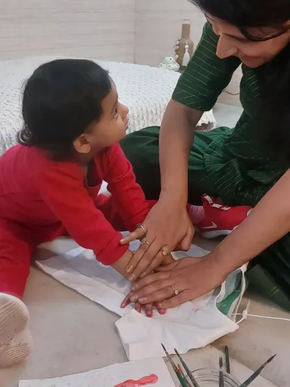 A precious moment of co-creation. I guide each child, no matter how young, to help them make their mark and feel proud of their work.