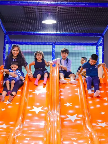 Whooshing down our giant multi-lane slide. It's wide enough for friends to slide down together and is a favorite for kids of all ages, providing endless excitement and laughter.