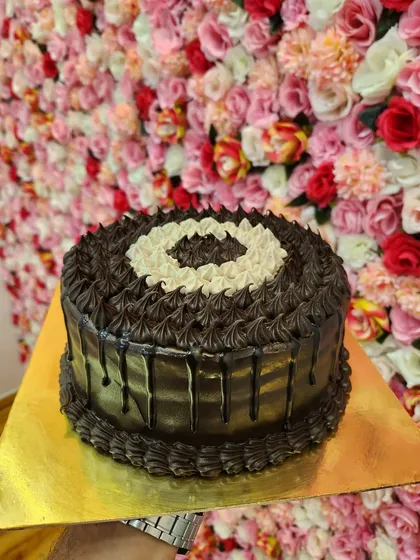 My Super Truffle cake is for serious chocolate lovers. It's a rich, dark chocolate cake with a chocolate drip and layers of chocolate frosting. It's pure, unadulterated chocolate goodness.