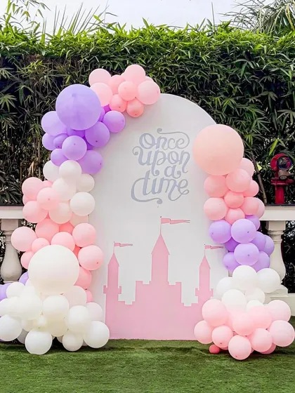 Another view of the enchanting "Once Upon a Time" backdrop. The soft pink, purple, and white balloons create a cloud-like effect around the castle design, perfect for a fairytale celebration.