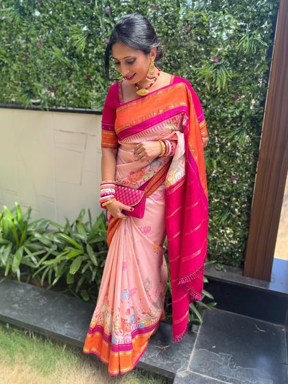 A full-length view of the client in her vibrant floral saree, a perfect outfit for a summer wedding or event.