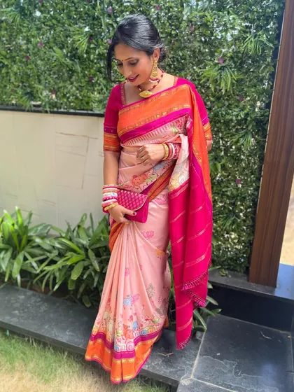 A full-length view of the client in her vibrant floral saree, a perfect outfit for a summer wedding or event.