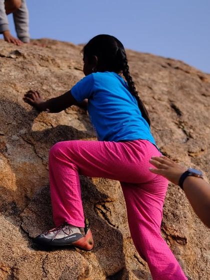 A helping hand for a new climber. We believe everyone should have the opportunity to experience climbing, regardless of their access to resources.