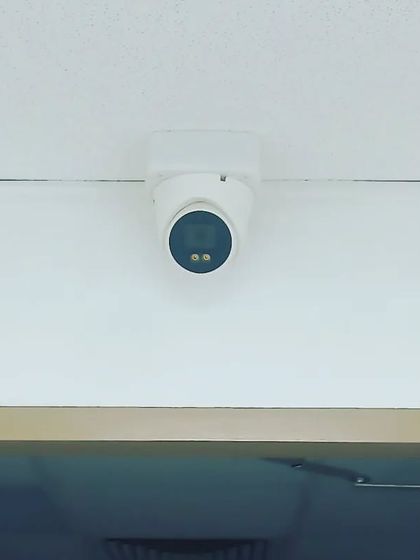 A cleanly installed dome camera, perfect for monitoring the entrance of an office or shop.