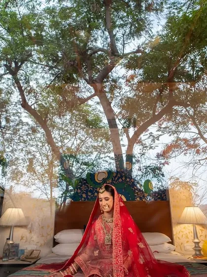 An artistic double-exposure shot, blending a portrait of the bride with the natural scenery of her wedding location.