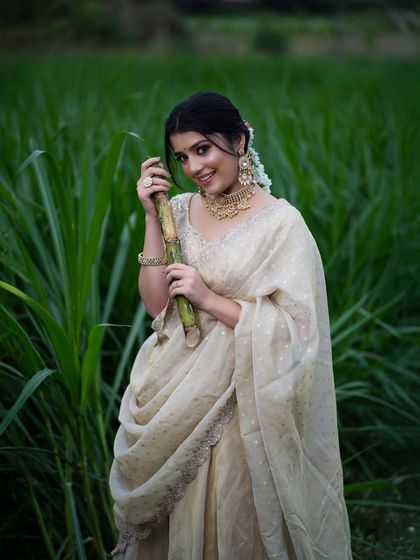 A beautiful portrait of the model holding sugarcane, with the soft evening light creating a dreamy and rustic atmosphere.