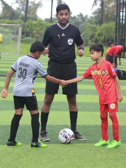 The pre-match handshake between captains at a U11 Grassroots Football Fiesta game.