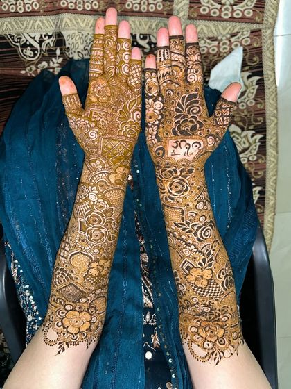 The full view of this bridal floral mehendi. The design is asymmetrical, with different patterns on each arm for a unique look.