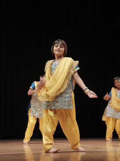 Our student striking a confident pose during her group performance. We create a supportive environment where every child feels like a star.