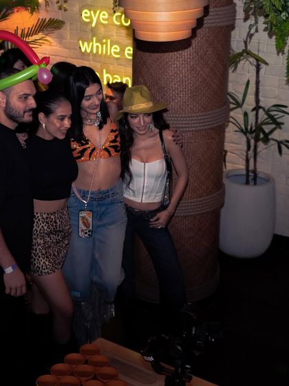 Posing with friends and fans after a set. The balloon hat shows the playful, fun atmosphere I encourage at all my gigs.