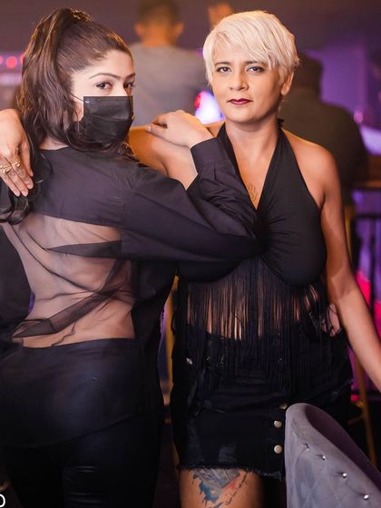 Two stylish guests posing for a photo.