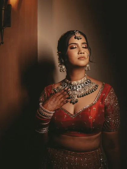 A royal bridal portrait with dramatic lighting. We use shadows to create a moody and artistic shot that highlights the bride's features and jewelry.