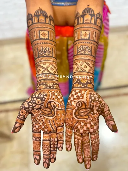 A full view of a bridesmaid's henna with swan motifs.