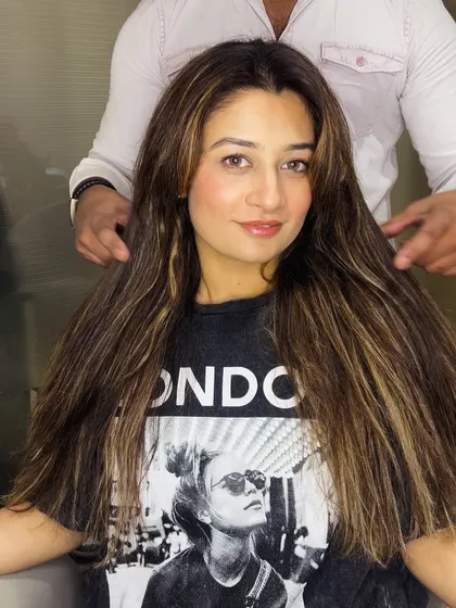 A close-up of the client's new hair color. The highlights are perfectly placed to create a natural and flattering look.