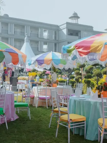 A Haldi themed 'Rang Rang Mein' (In Every Color), featuring vibrant, multi-colored umbrellas and pastel seating for a playful and festive atmosphere.