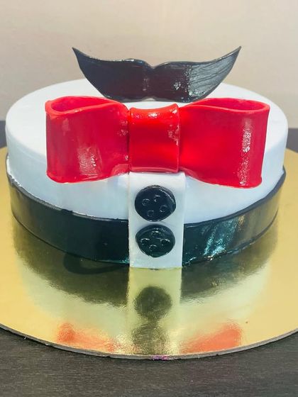 A fun and dapper cake for a dad or husband, designed to look like a shirt and bow tie with a mustache topper.