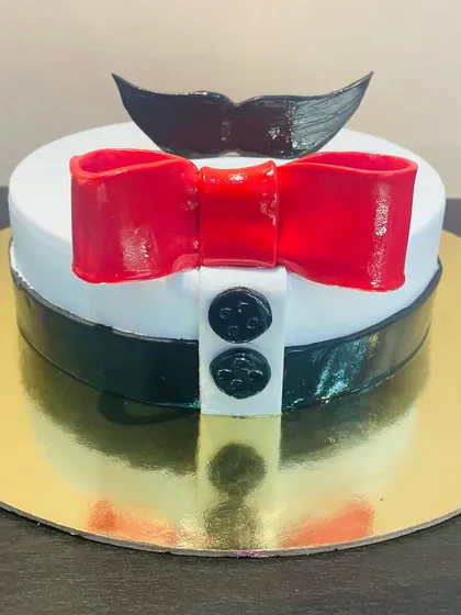 A fun and dapper cake for a dad or husband, designed to look like a shirt and bow tie with a mustache topper.