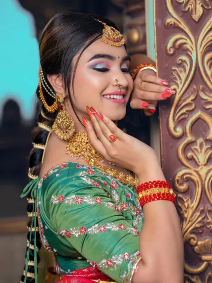 A side profile showing the traditional braid and hair accessories. The makeup is soft and romantic.