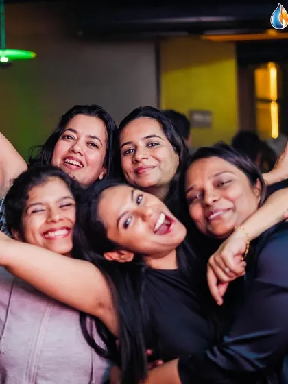 The pure joy of a group hug on the dance floor. It's all about friendship and good times.