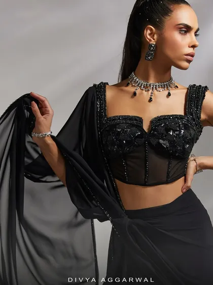 A close-up of the Hertha set's hand-adorned corset blouse, paired with a pre-draped concept saree to amplify the elegance of your look.