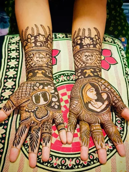 The complete view of this special baby shower mehandi, showcasing the combination of portrait work, symbolic motifs, and traditional patterns.
