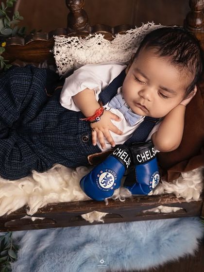 Even the smallest sports fans can show their team spirit. This baby is peacefully dreaming, wearing tiny boxing gloves representing his family's favorite team.