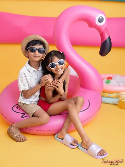 Posing with the giant flamingo, these two are the picture of summer fun. I love how their personalities shine in this playful sibling portrait.